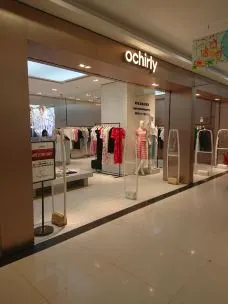 A customer is seen by an Ochirly store in Shanghai, China, 13