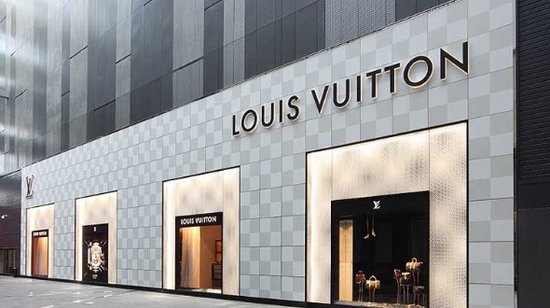 Queue of shoppers outside Louis Vuitton store on Champs Elysees in Paris  France